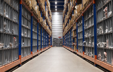 Centered view of a warehouse aisle.